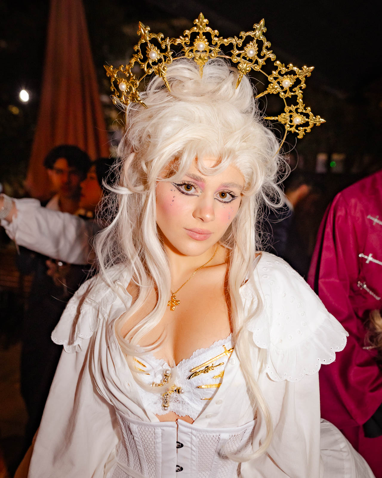 Party photographer London capturing woman in white wig and theatrical costume at a stylish nightclub event