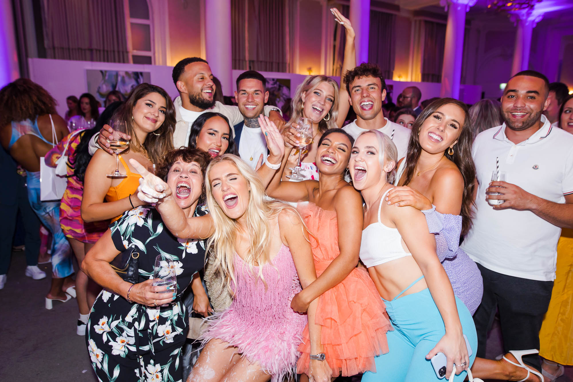 Party photographer London capturing a group of friends celebrating in a vibrant art event