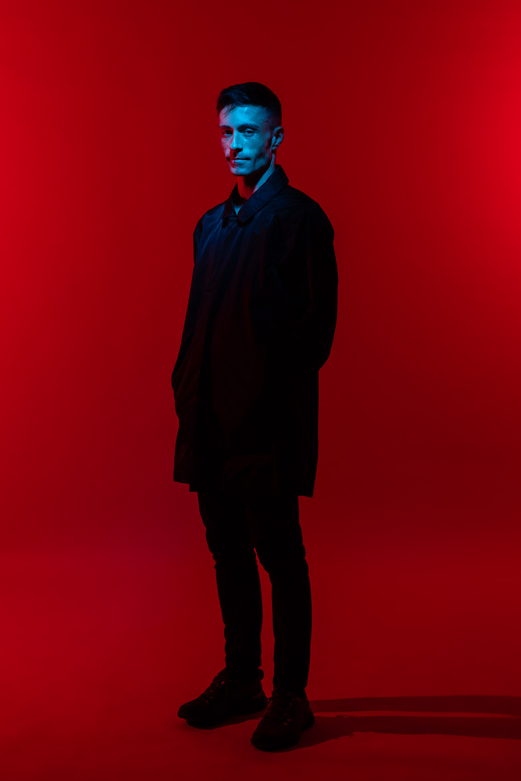 Cinematic musician portrait photography in London with red and blue studio lighting