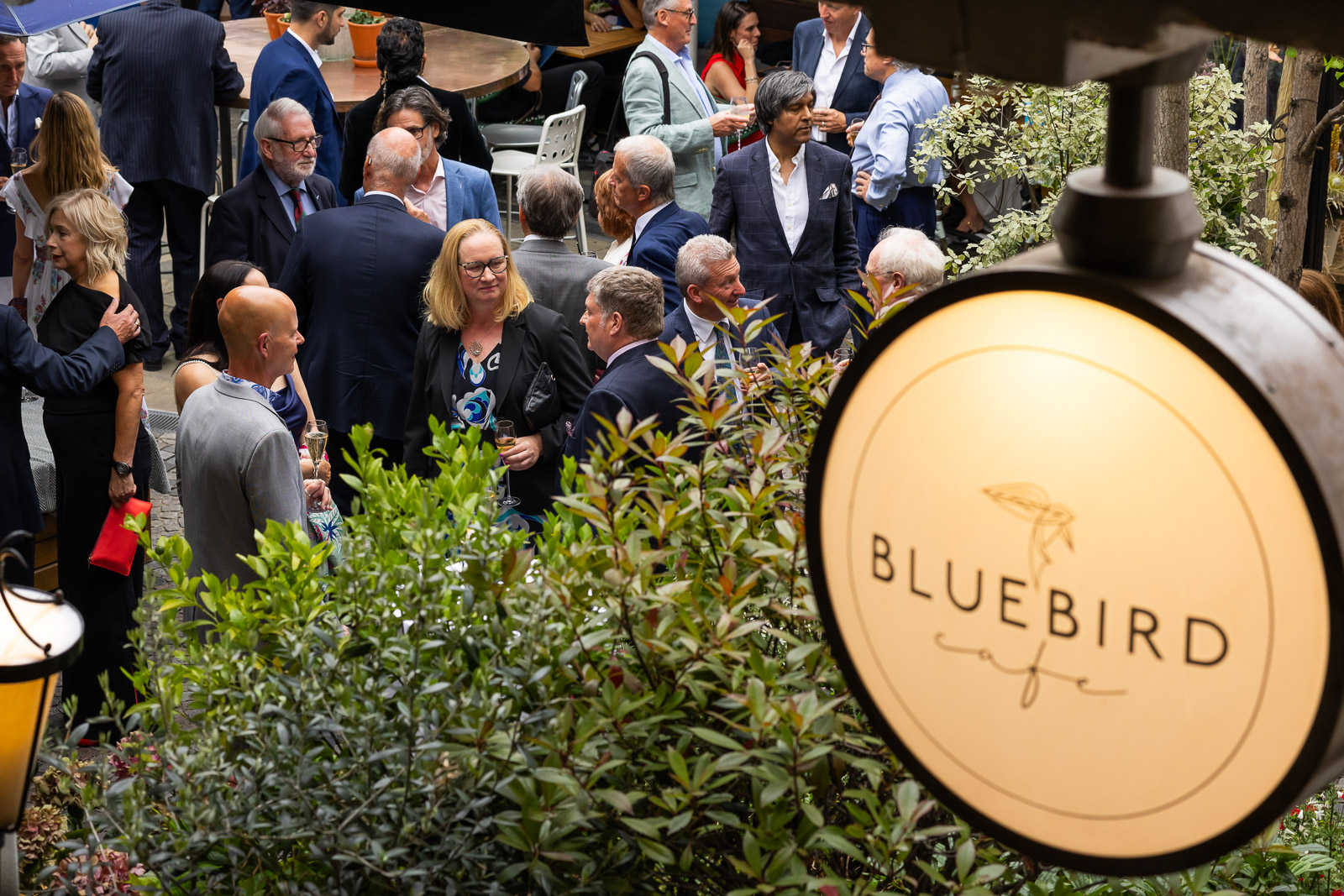 Wide view of guests networking at a corporate event at Bluebird London