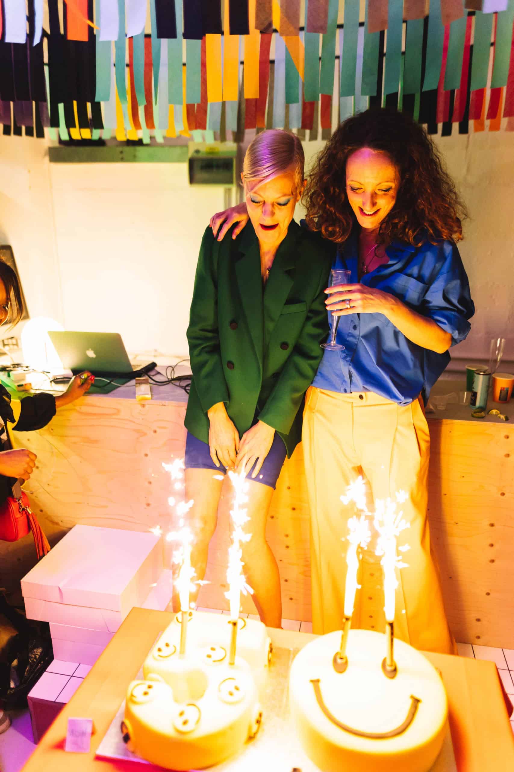 50th birthday celebration with two women, birthday cakes and sparklers at a party in London