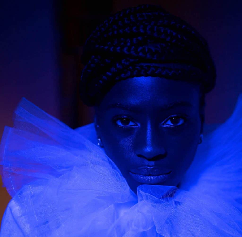 Blue — close-up portrait illuminated by deep cobalt blue light, fine art photograph by Twiggles