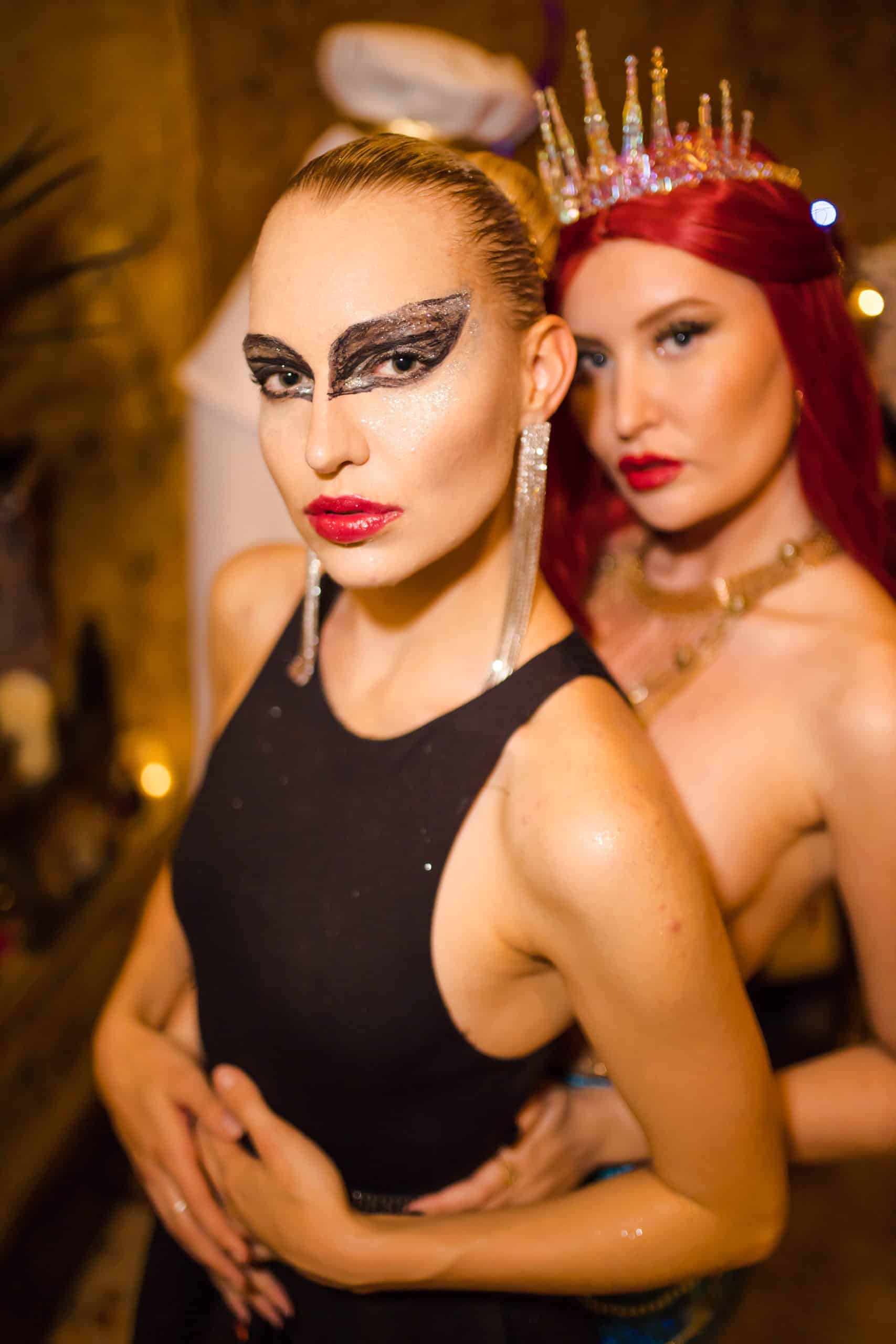 Two women in dramatic costumes and makeup at a birthday party in London