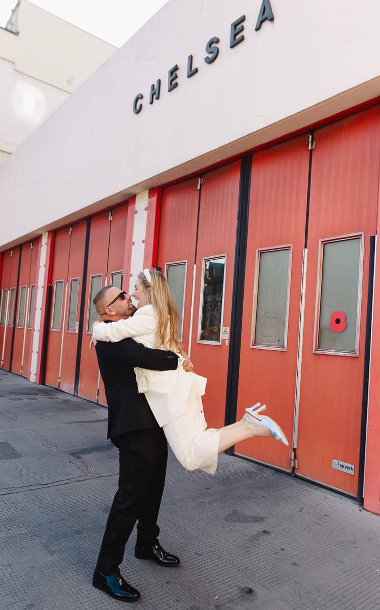 Newly married couple kissing outside Chelsea Old Town Hall in London