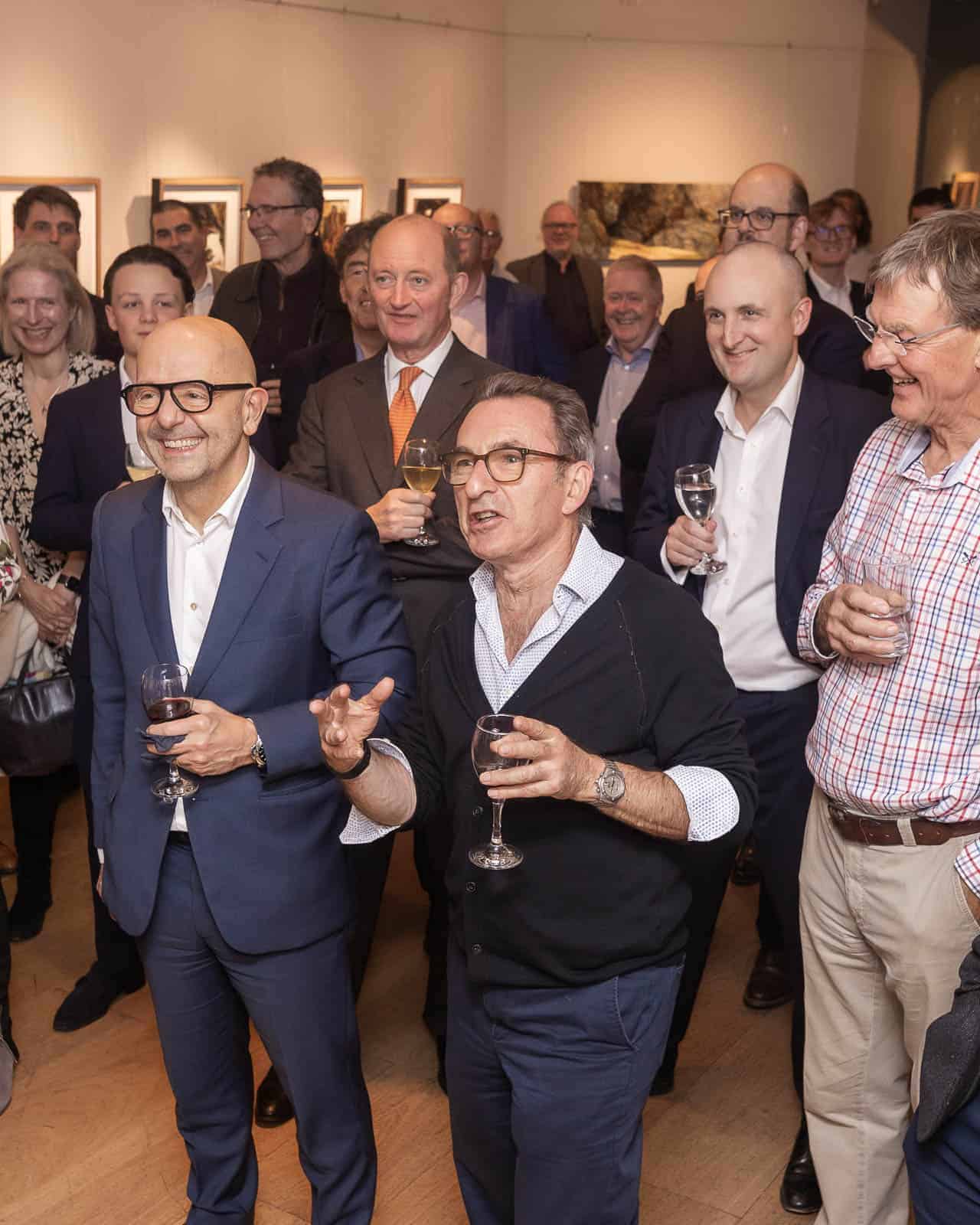 Guests networking at a corporate event reception in London gallery setting