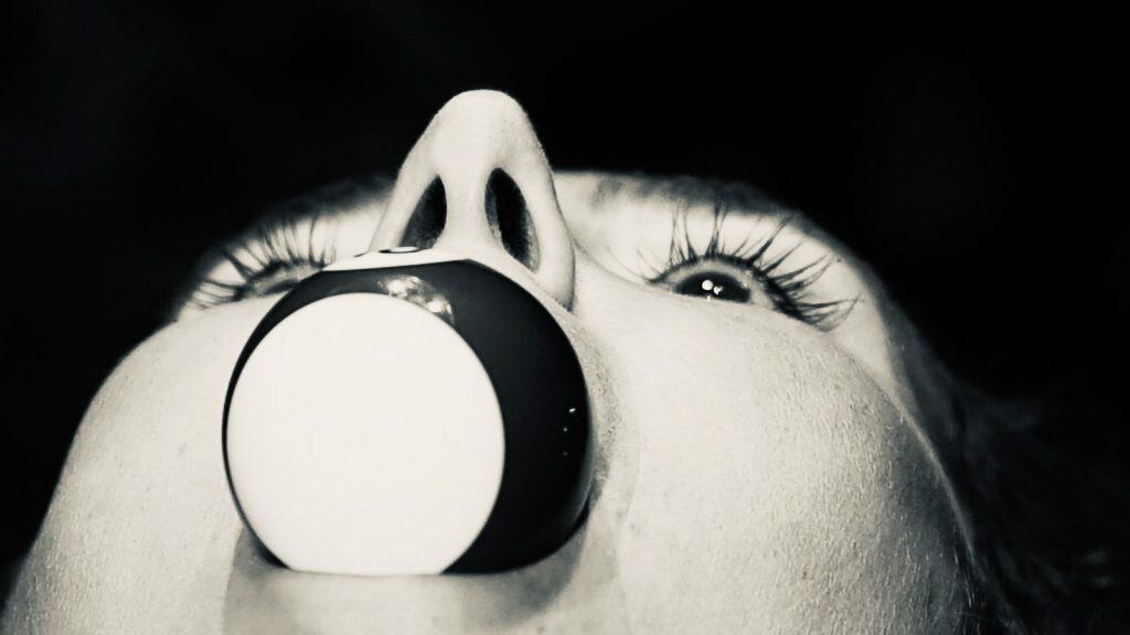 Hitchcock, a striking black and white fine art photograph by London artist Twiggles, featuring a dramatic close-up portrait with expressive eyes, long eyelashes and a surreal circular form