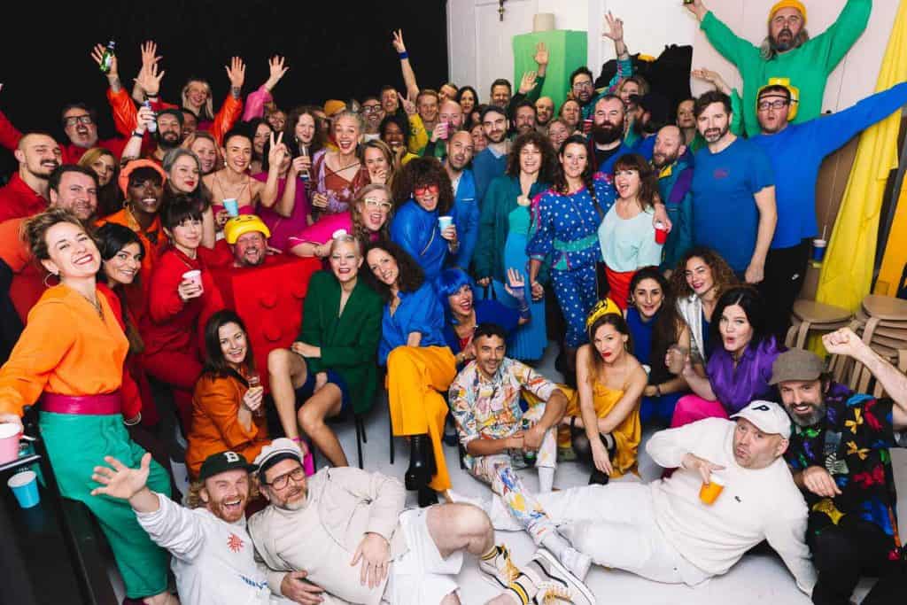 Large group enjoying a colourful London event, photographed by Twiggles UK