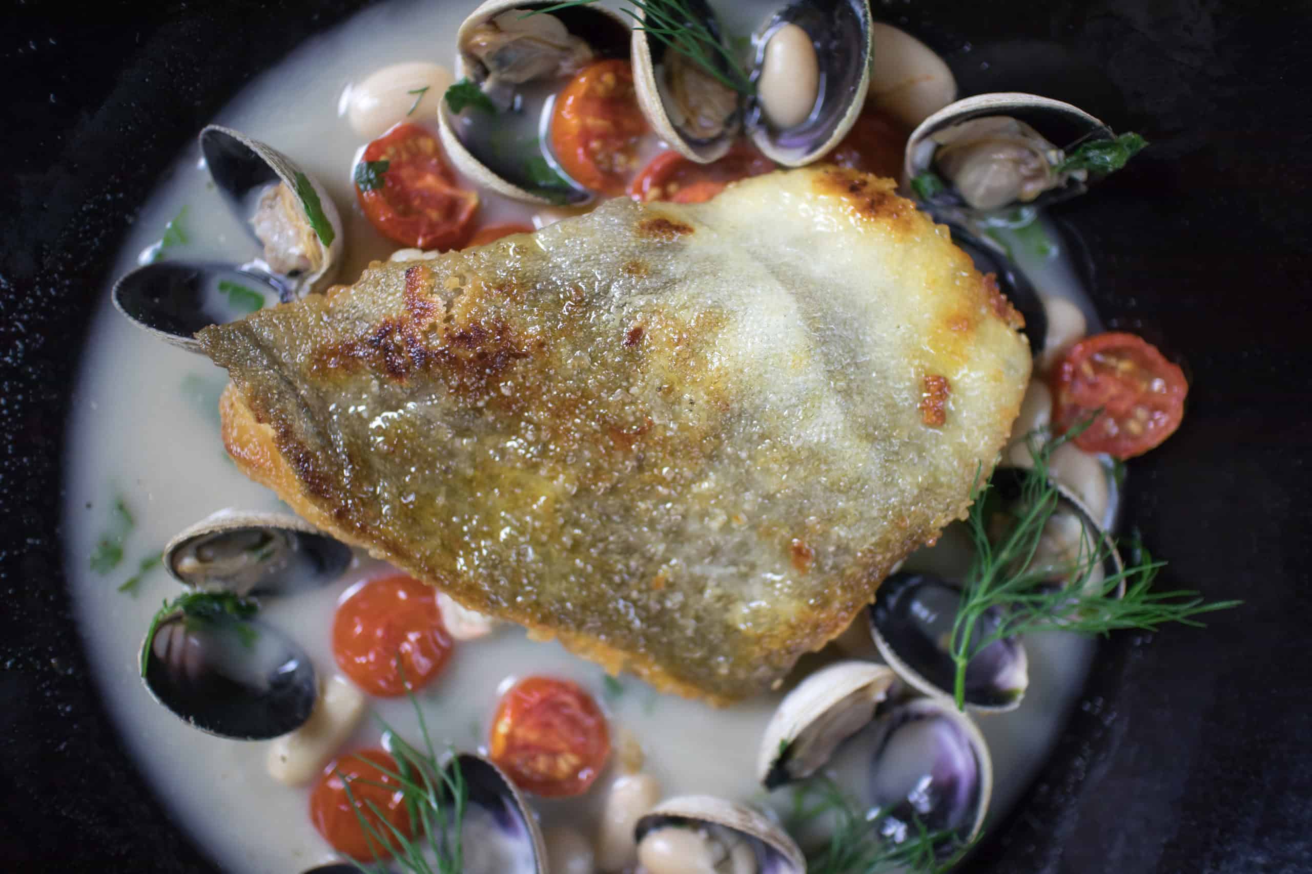 Crispy fish dish with mussels and tomatoes photographed for a Mayfair restaurant